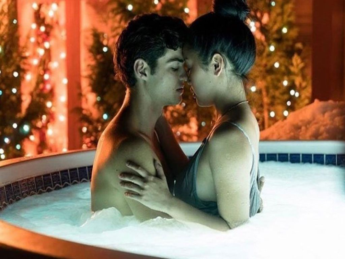 Noah Centineo and Lana Condor sharing a passionate kiss in the hot tub scene from To All the Boys I've Loved Before, capturing the essence of young romance.