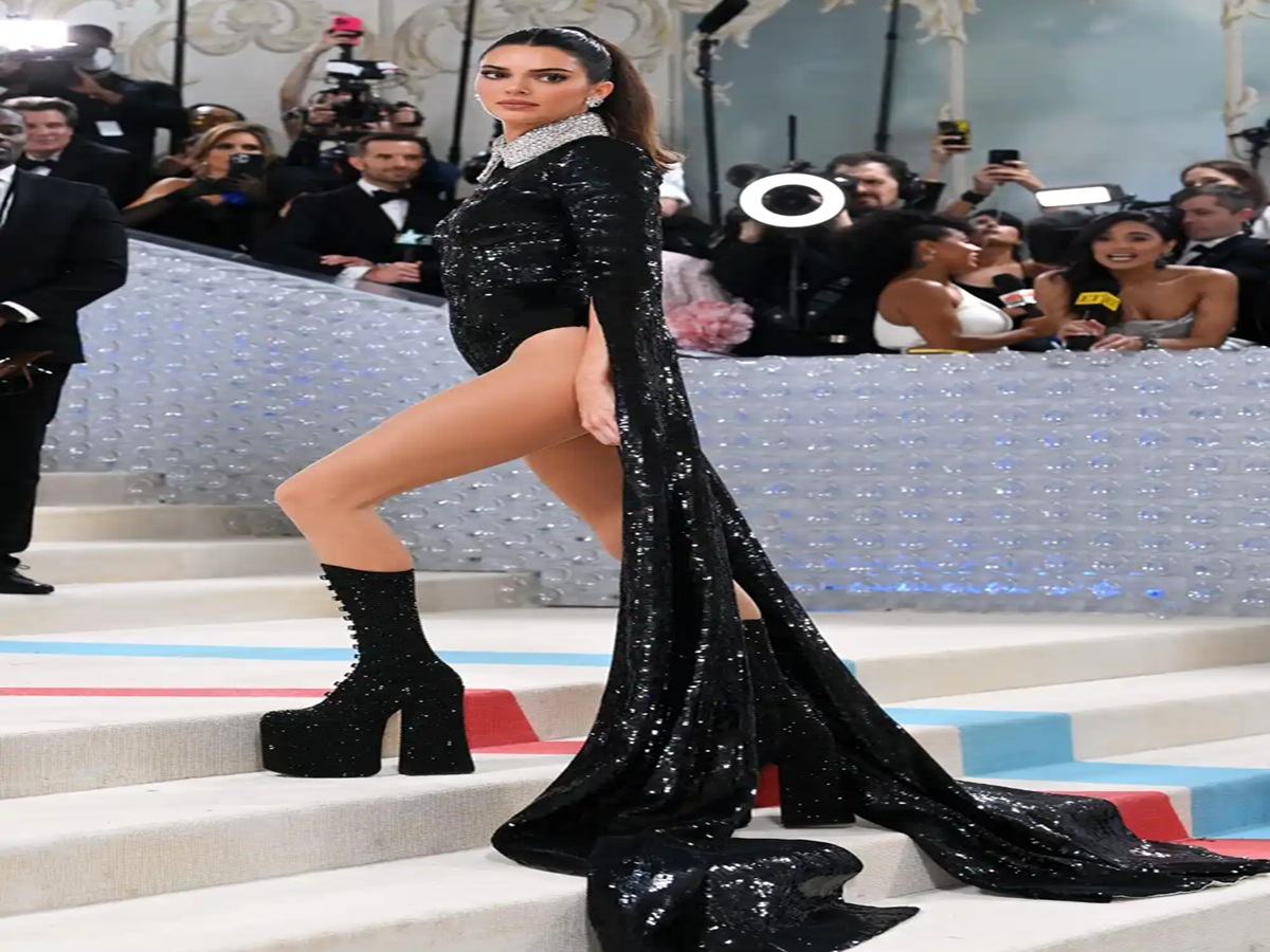 Kendall Jenner in bold runway looks for Marc Jacobs, including sheer tops, feathered coats, and dramatic styling