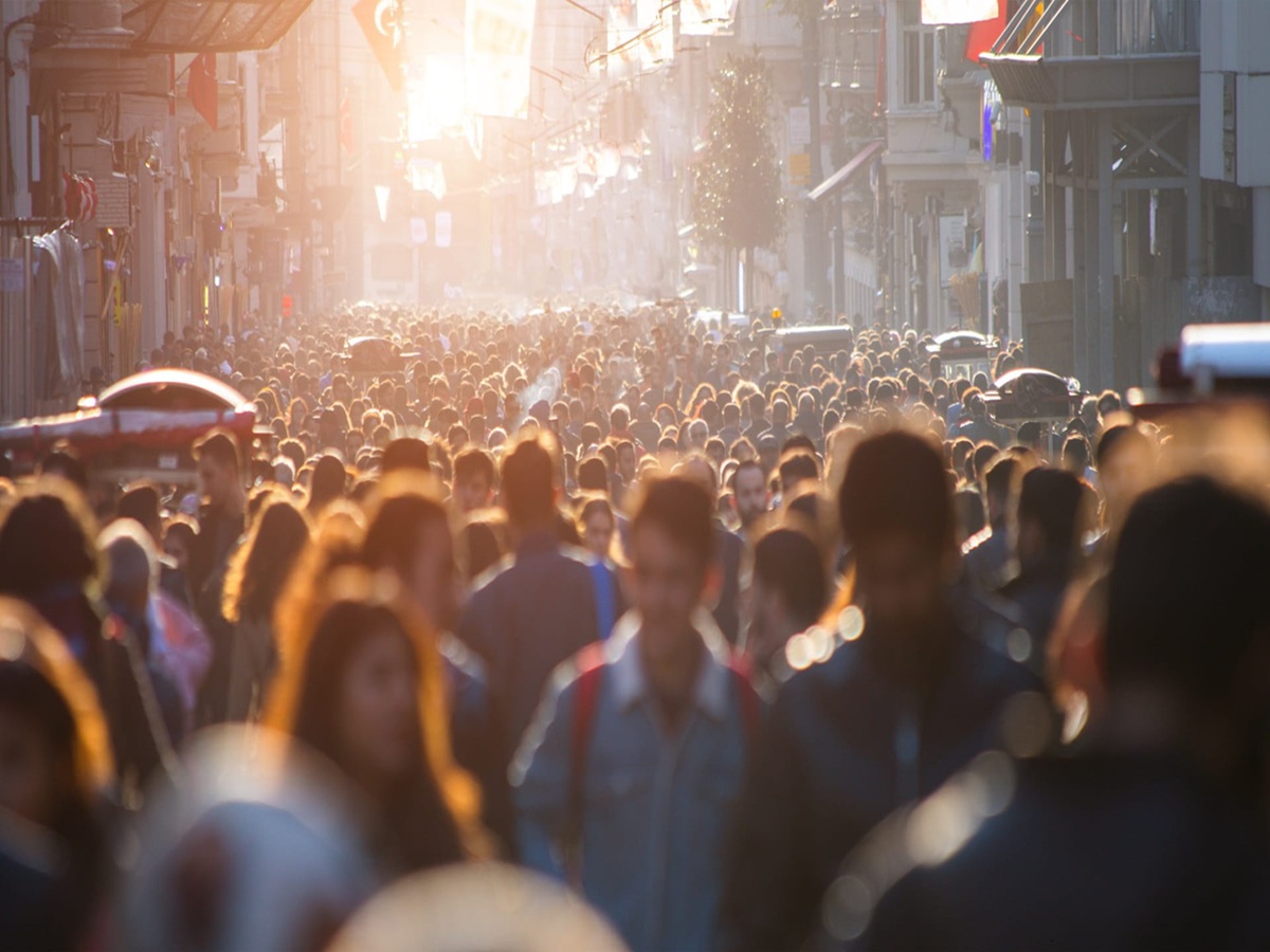 People wearing masks in a crowded public space