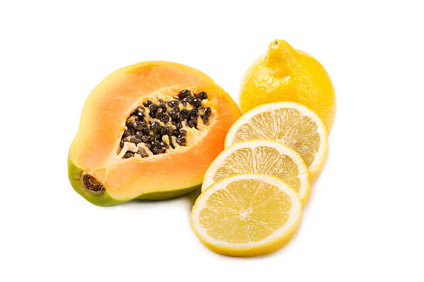 Lemon slices placed next to chopped papaya cubes.
