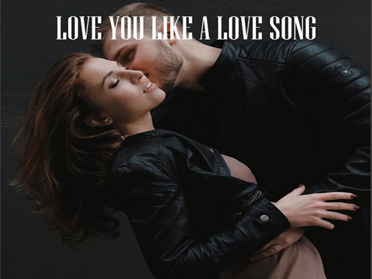 Selena Gomez striking a pose against a vibrant, pop-art-inspired backdrop from the "Love You Like a Love Song" visuals