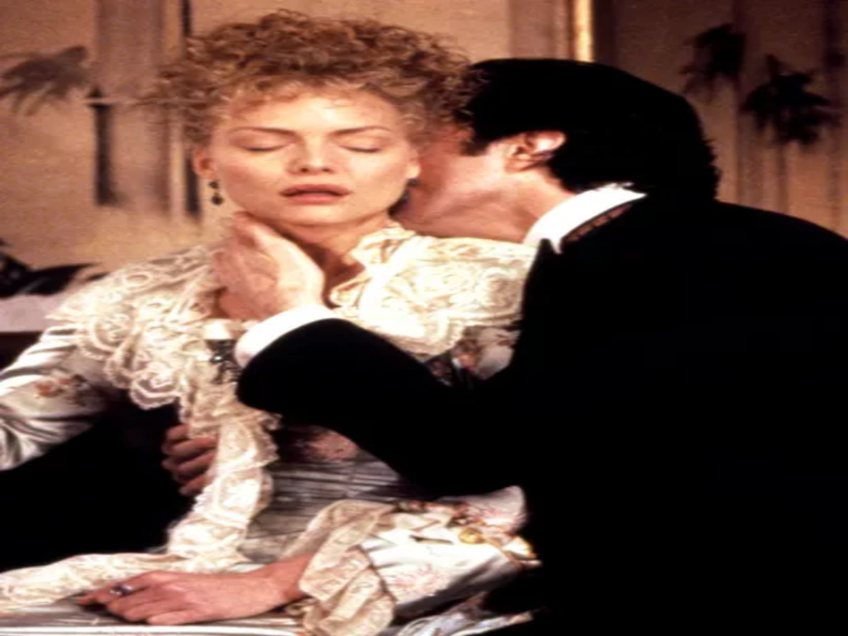 Newland Archer and Countess Ellen Olenska poised for a kiss in "The Age of Innocence," highlighting their emotional connection amidst societal constraints.