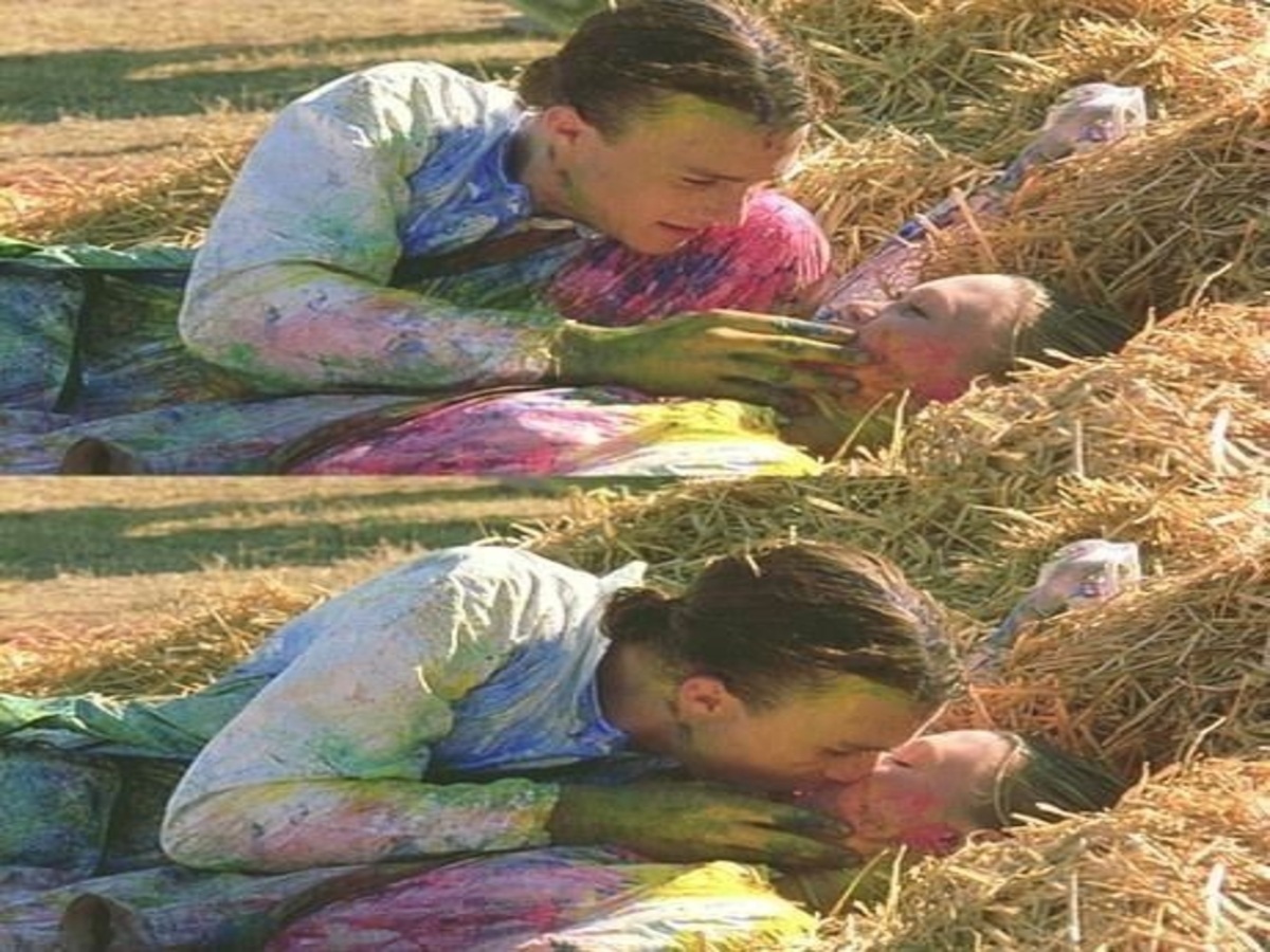 Kat and Patrick sharing a playful first kiss during the paintball scene in "10 Things I Hate About You," showcasing their chemistry and youthful romance.