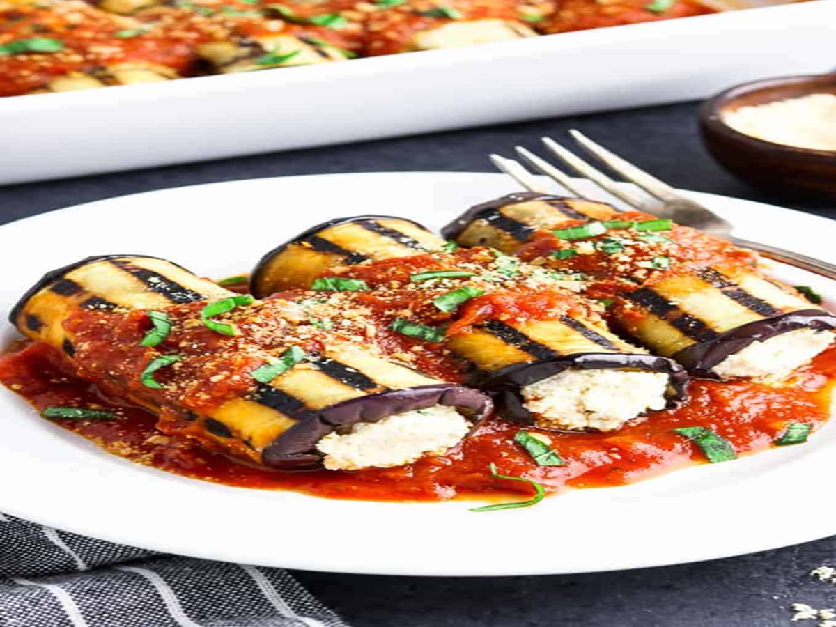 Roasted eggplant slices rolled with ricotta filling, baked in marinara sauce