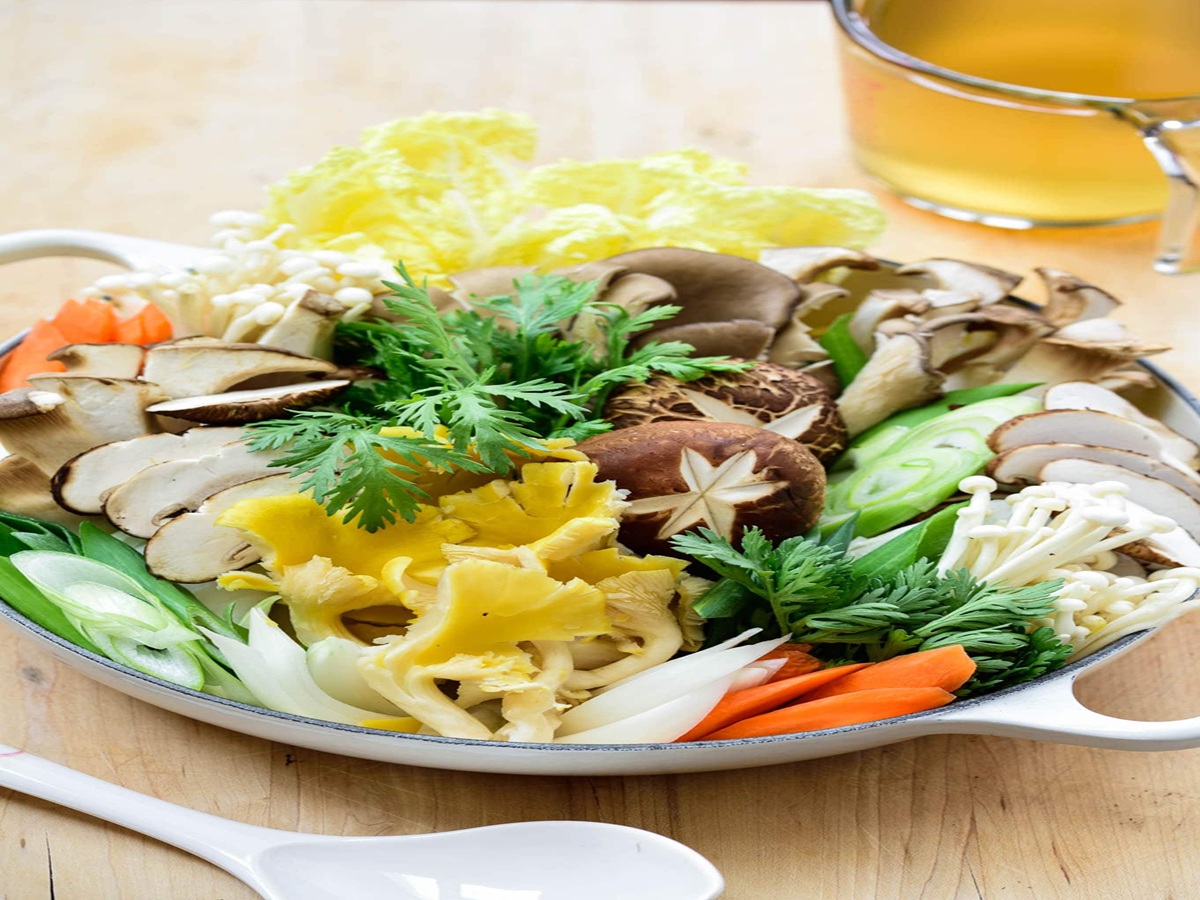 Neatly arranged Korean jeongol hot pot with sliced beef, mushrooms, tofu, and vegetables in a shallow pot