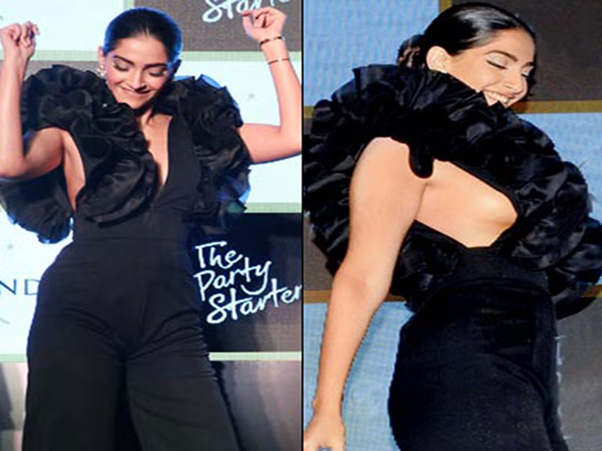 Sonam Kapoor Ahuja at a fashion event in a designer gown, captured during a minor wardrobe malfunction