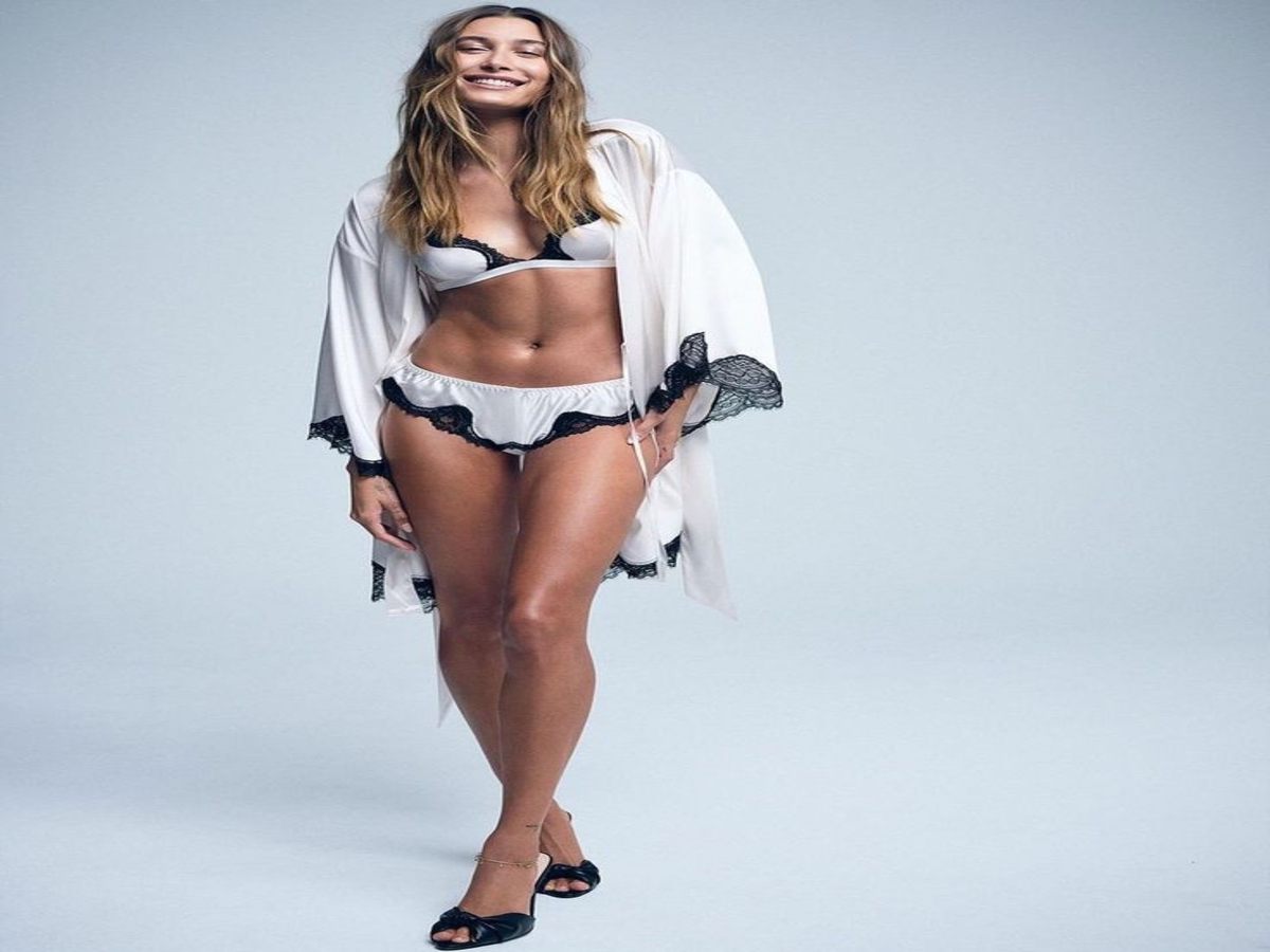 Individual modeling a sophisticated lingerie set with a flowing robe, displaying elegance and style.