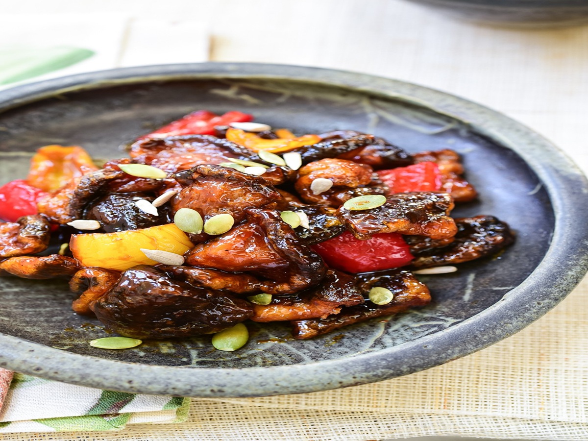 A plate of golden, crispy mushrooms coated in a glossy sweet and spicy glaze, served at a Michelin-starred temple cuisine restaurant in Seoul