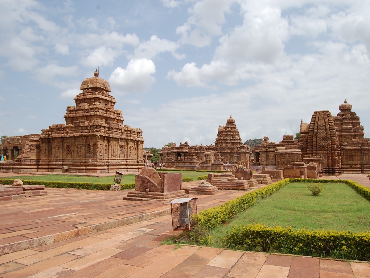 Front view of Virupaksha Temple in Pattadakal, Karnataka, showing its towering Dravidian vimana and intricately carved sandstone pillars