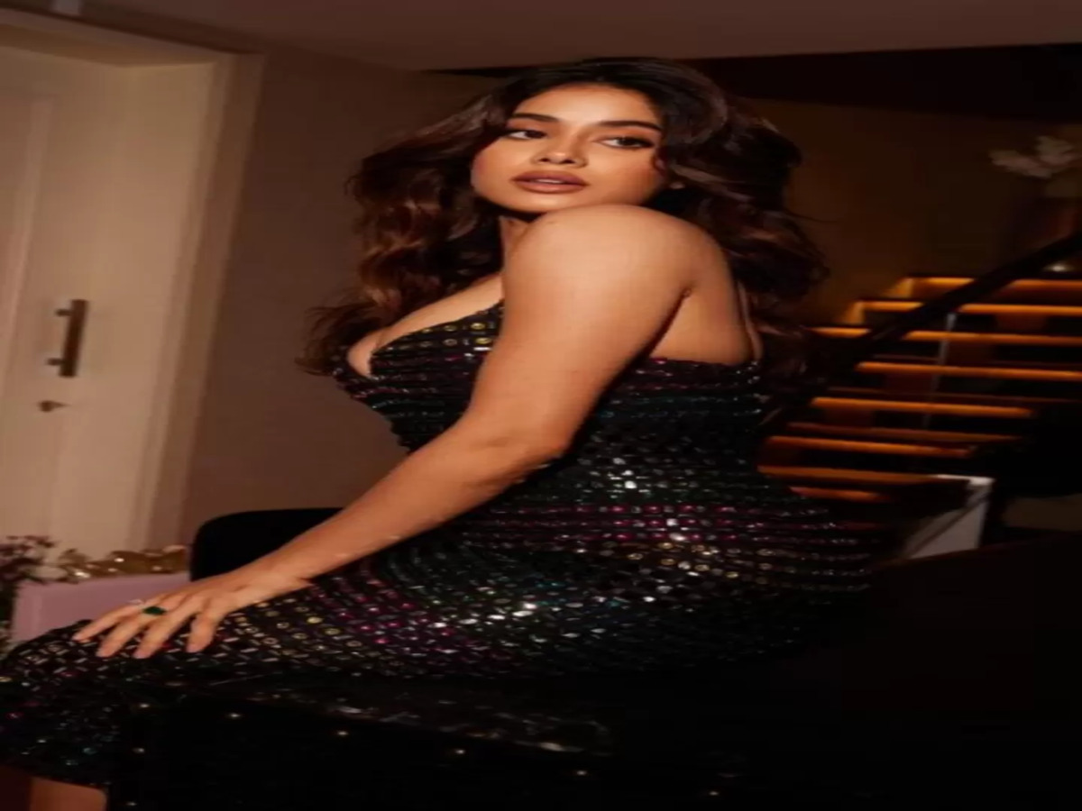 Janhvi Kapoor in a glamorous black sparkling dress, radiating elegance during a stylish photoshoot.