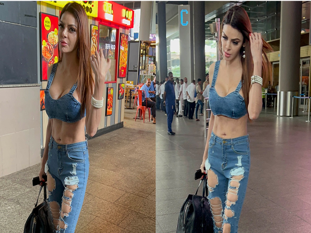 Sherlyn Chopra looking effortlessly stylish in ripped jeans and a white tank top, showcasing casual glamour