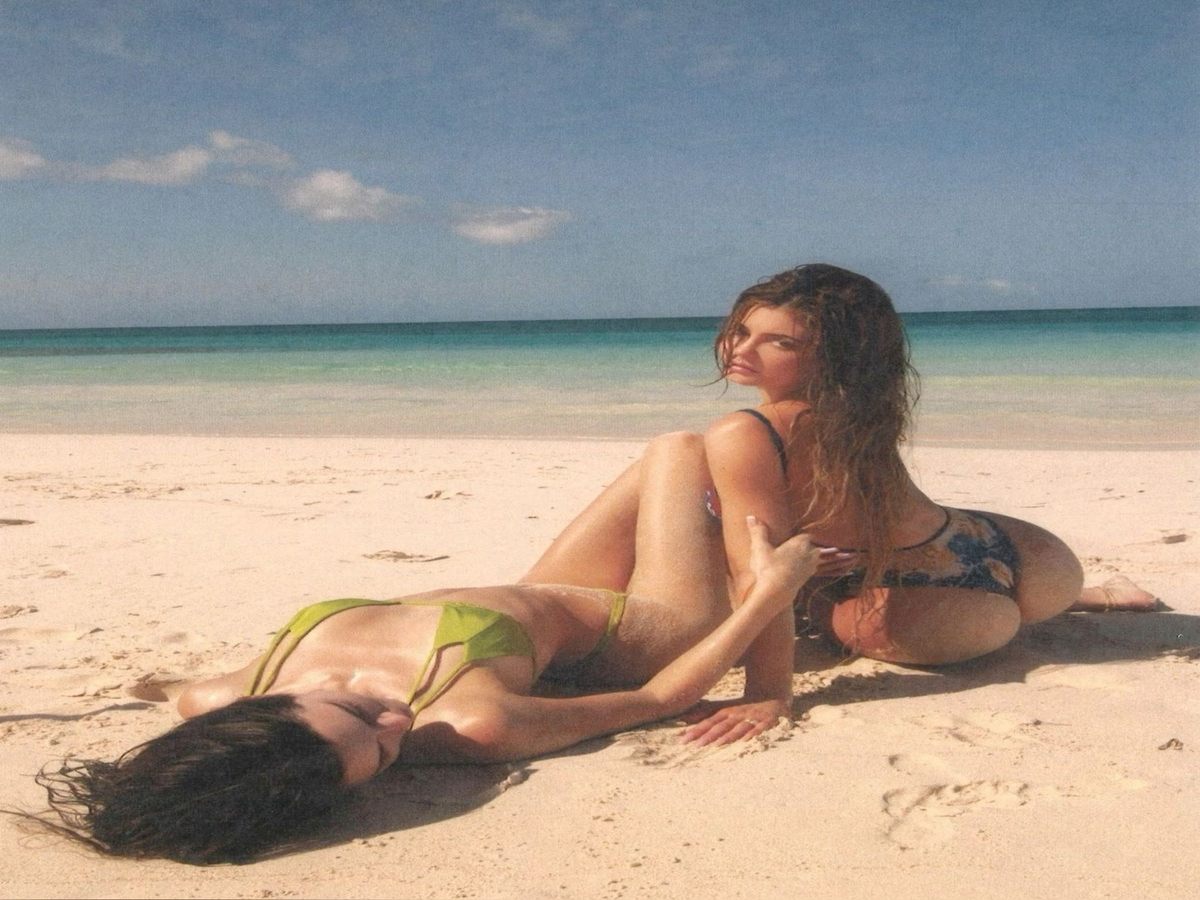 wo friends enjoying a sunny day at the beach in stylish swimwear