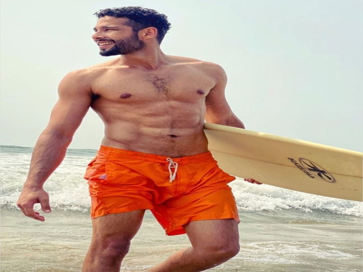 Siddhant Chaturvedi displaying his well-defined abs, captivating fans and creating a buzz with his charming appearance.