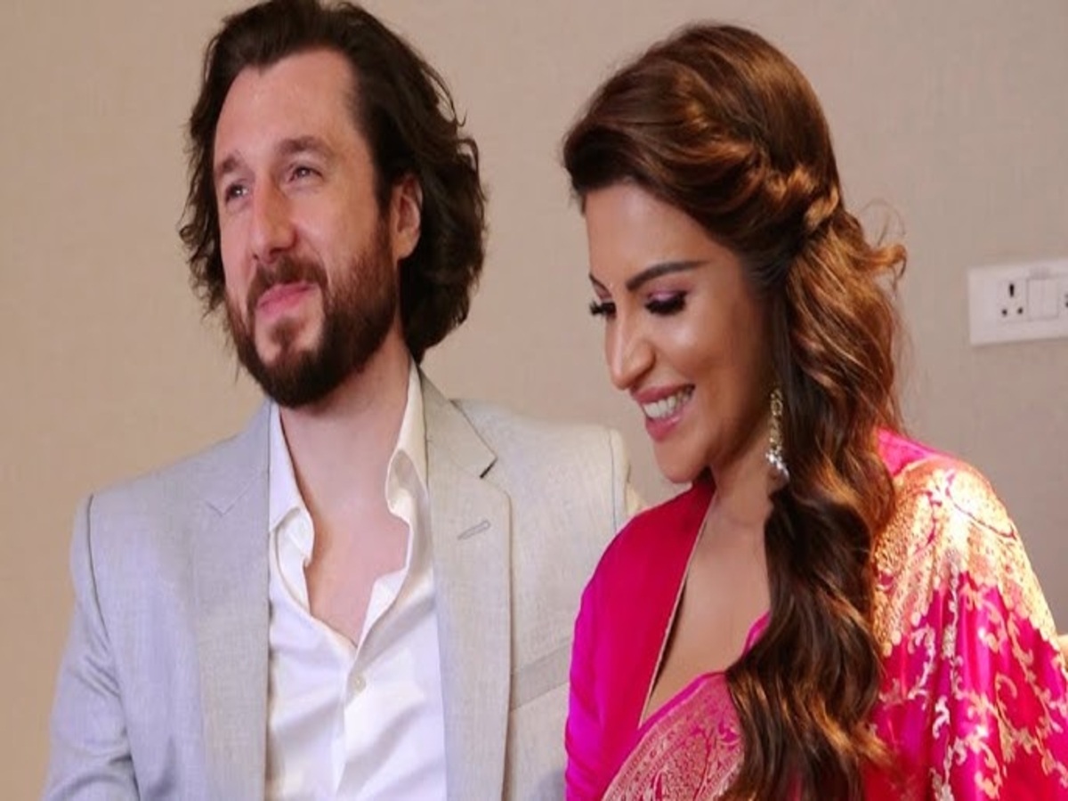 Shama Sikander kissing fiancé James Milliron at his birthday party, highlighting their affectionate relationship and engagement story.