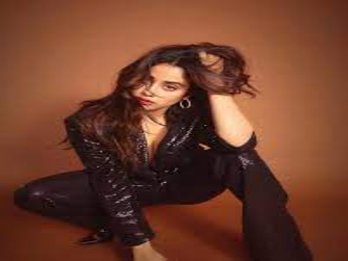 Janhvi Kapoor in a glamorous black outfit, showcasing her bold fashion choices during a stylish photoshoot.