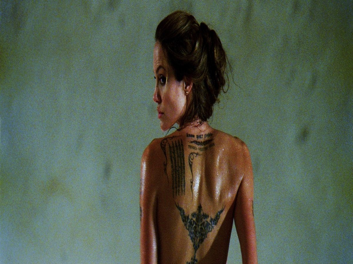 Angelina Jolie as Fox, the badass assassin, showcasing her power and allure.