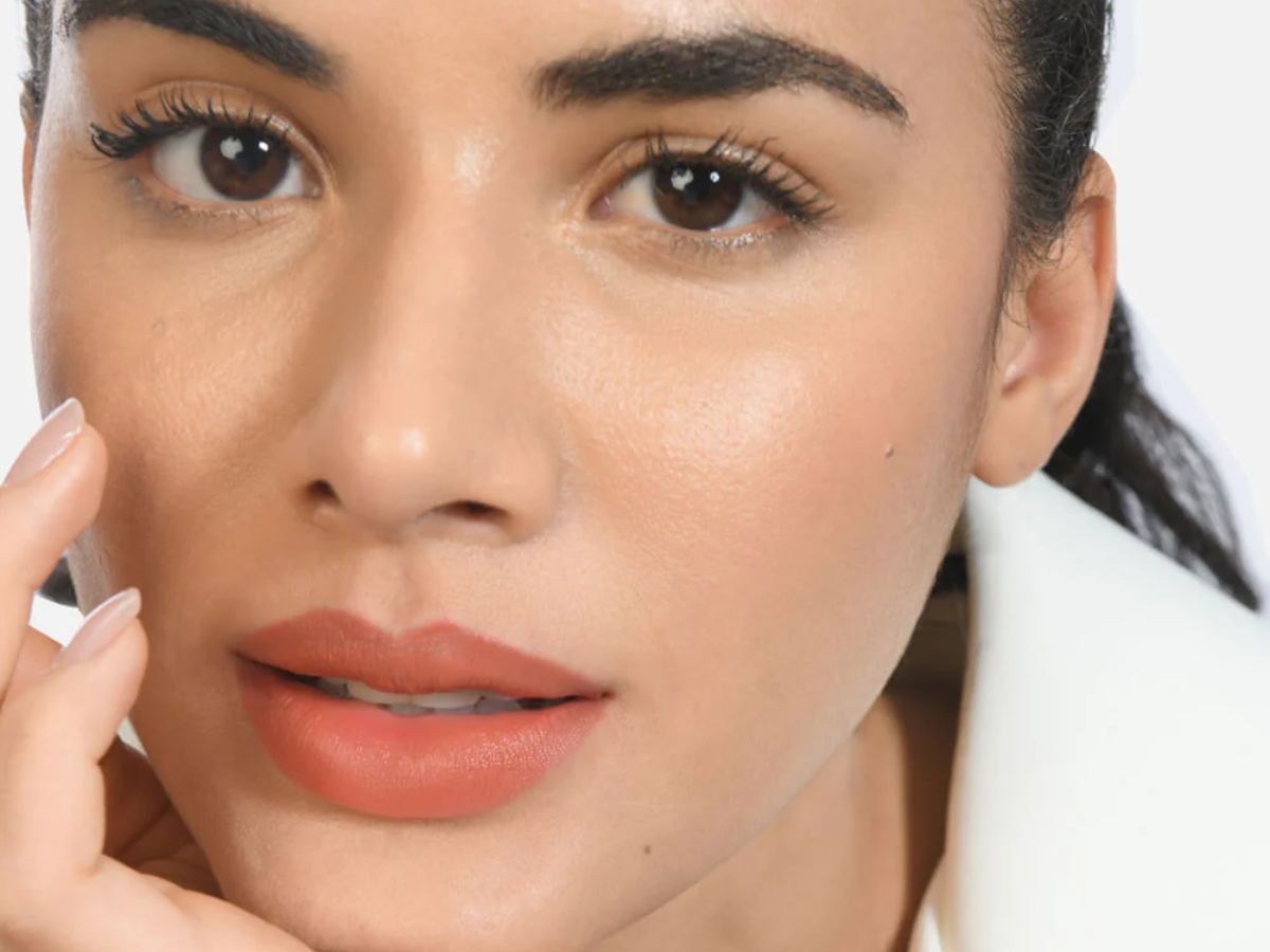 Light peach nude lipstick on soft makeup look