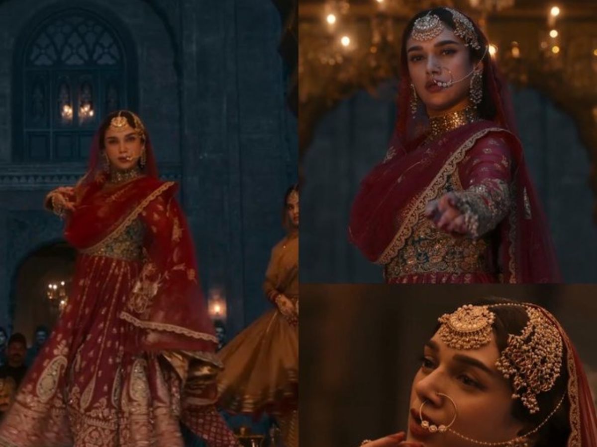 Aditi Rao Hydari as Bibbojaan from Heeramandi, wearing a red and gold embroidered lehenga, a large nath (nose ring), maang tikka, and choker, in a regal dance pose.