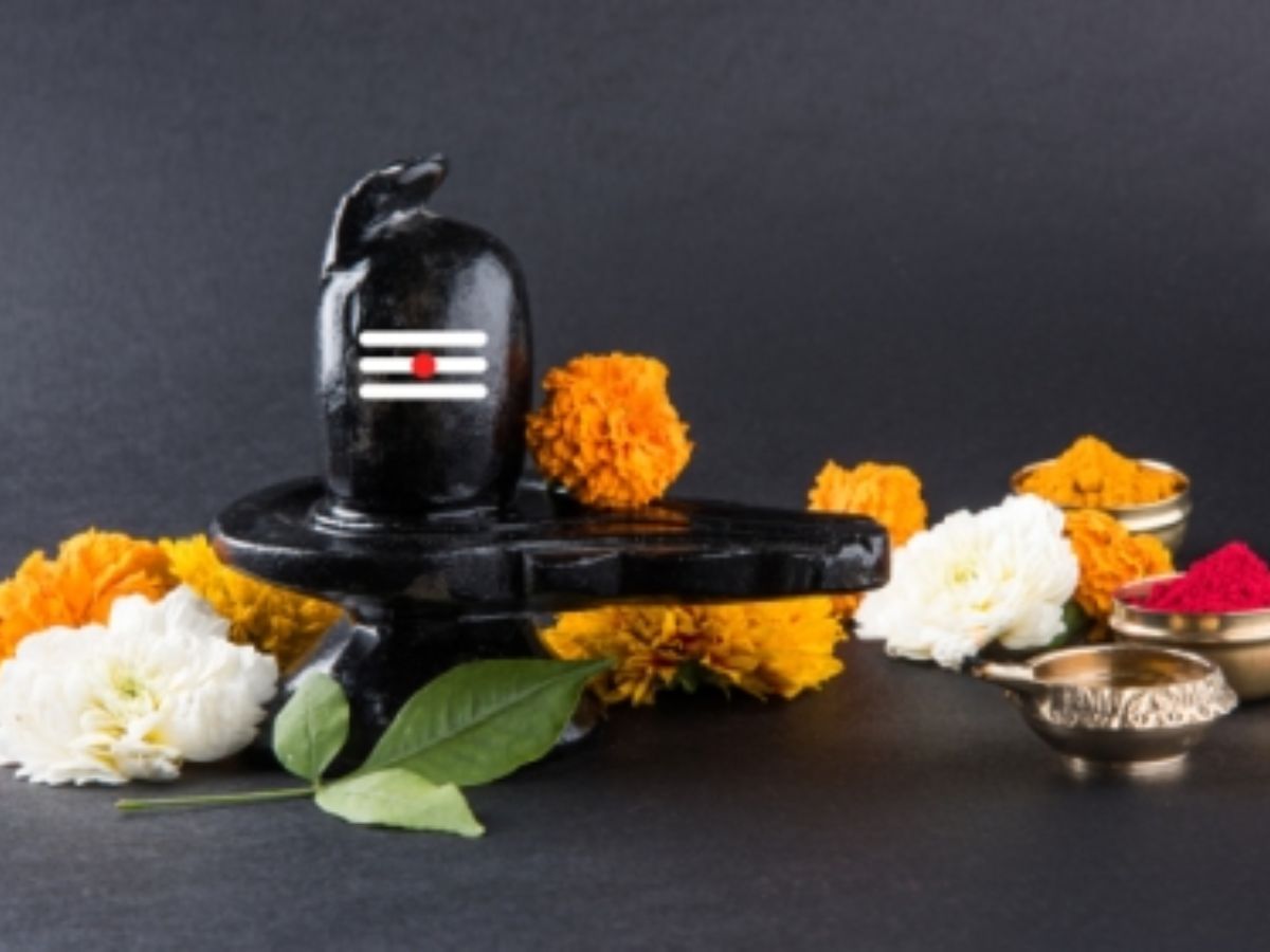 Fresh Bel Patra leaves placed on Shiva Linga with flowers.