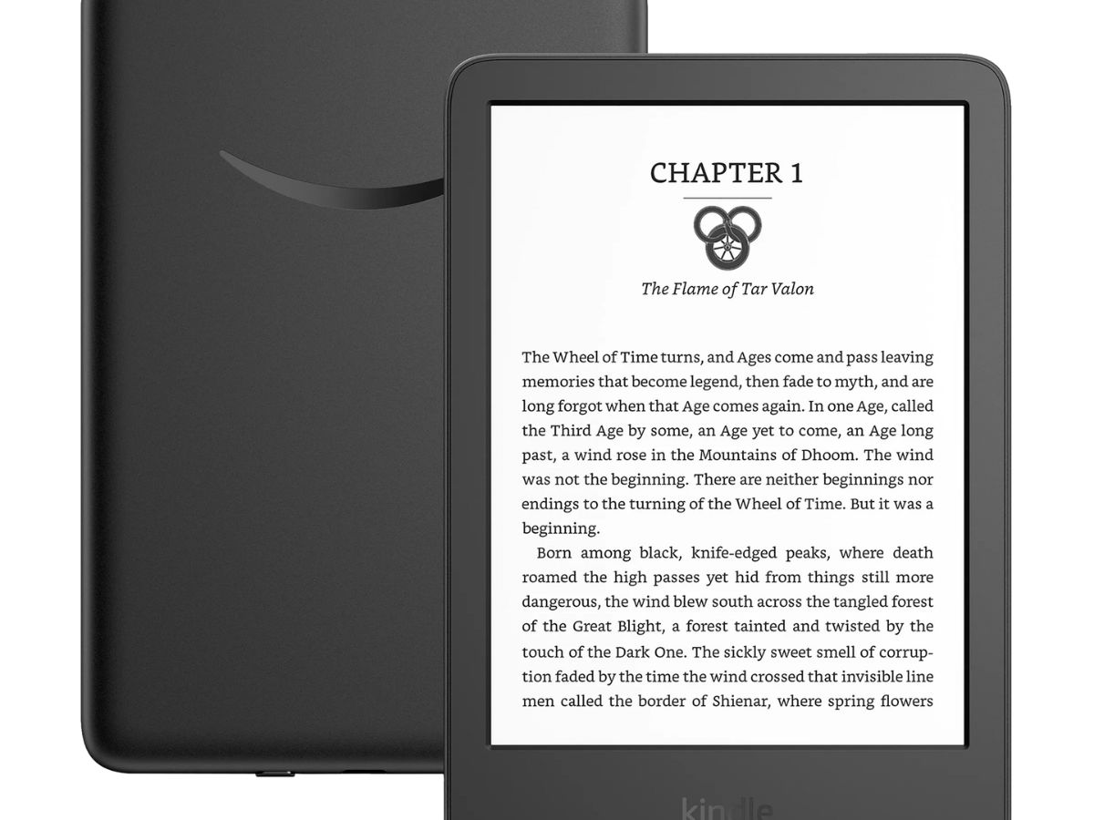 A black Amazon Kindle e-reader displaying 'Chapter 1' of 'The Flame of Tar Valon' from The Wheel of Time series, with text visible on the screen, indicating a digital reading experience.