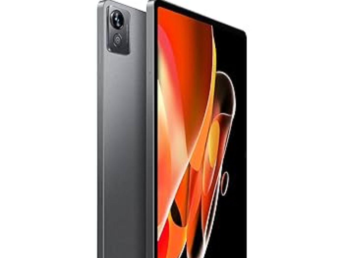 A dark grey tablet, possibly a Realme Pad, shown at an angle with its rear camera module visible and a vibrant, abstract wallpaper displayed on its screen, highlighting its sleek design.