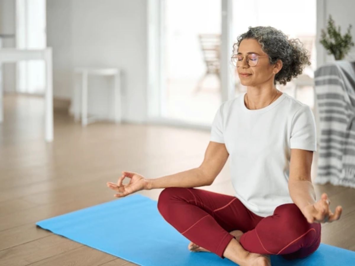 Person practicing deep breathing with closed eyes in a calm space.