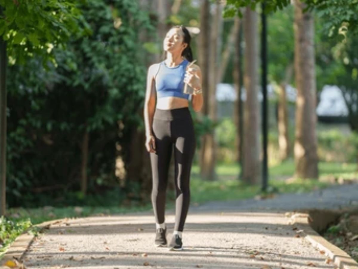Person walking peacefully in a lush green park.