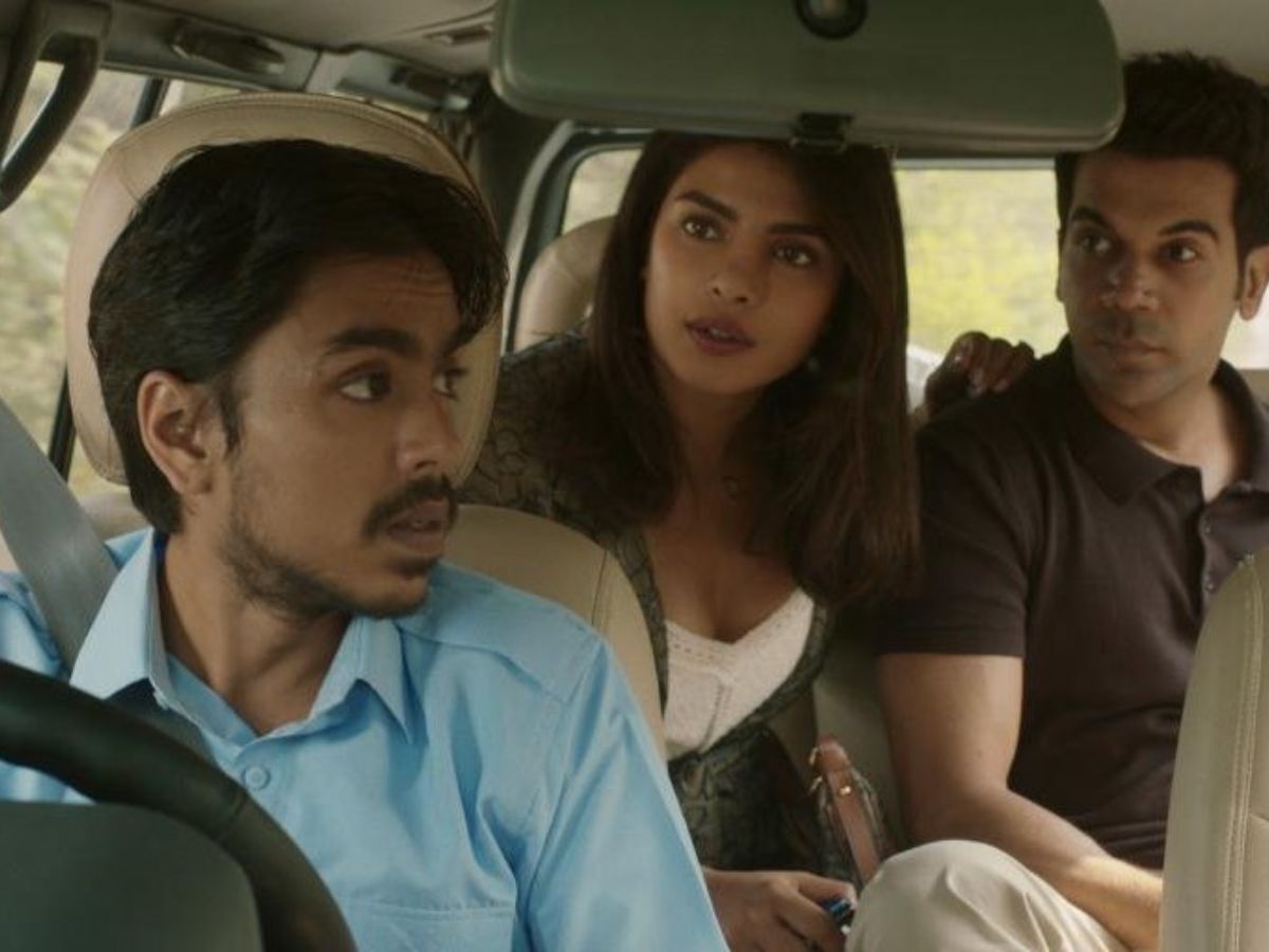 Adarsh Gourav as Balram in The White Tiger, driving his employers with quiet rebellion brewing behind his eyes