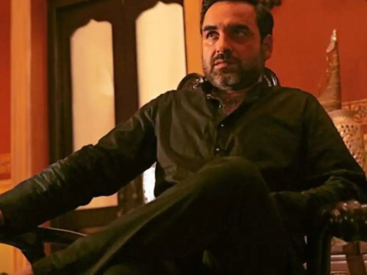 Pankaj Tripathi as Kaleen Bhaiya sitting confidently in traditional attire with a stern look