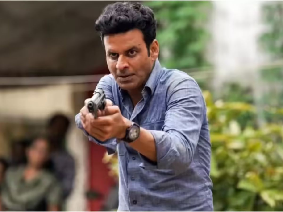 Manoj Bajpayee as Srikant Tiwari in formal clothes holding a phone, looking serious.