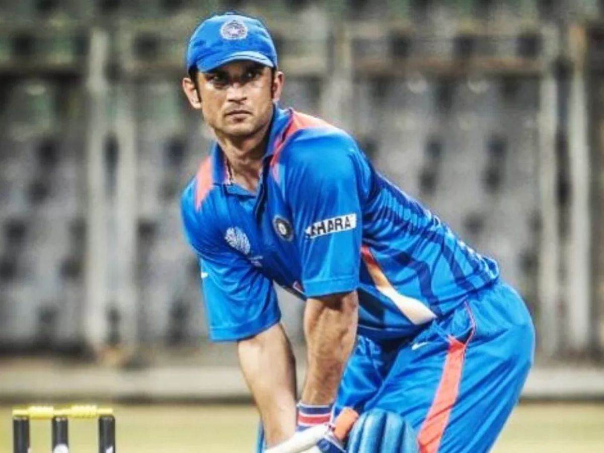 Sushant Singh Rajput in the Indian cricket team jersey, standing in batting position on a cricket field, portraying M.S. Dhoni in MS Dhoni: The Untold Story.