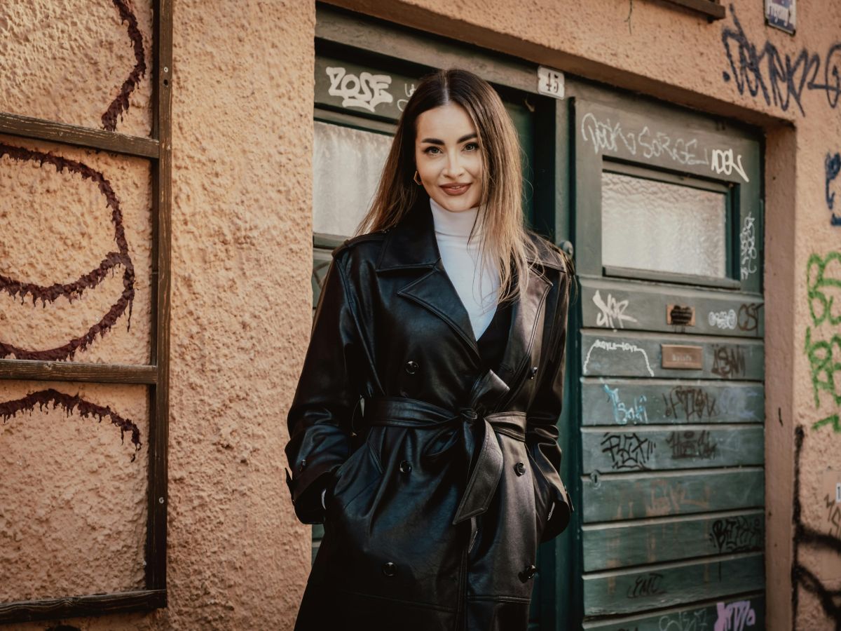 Woman in a black Saint Laurent leather trench coat