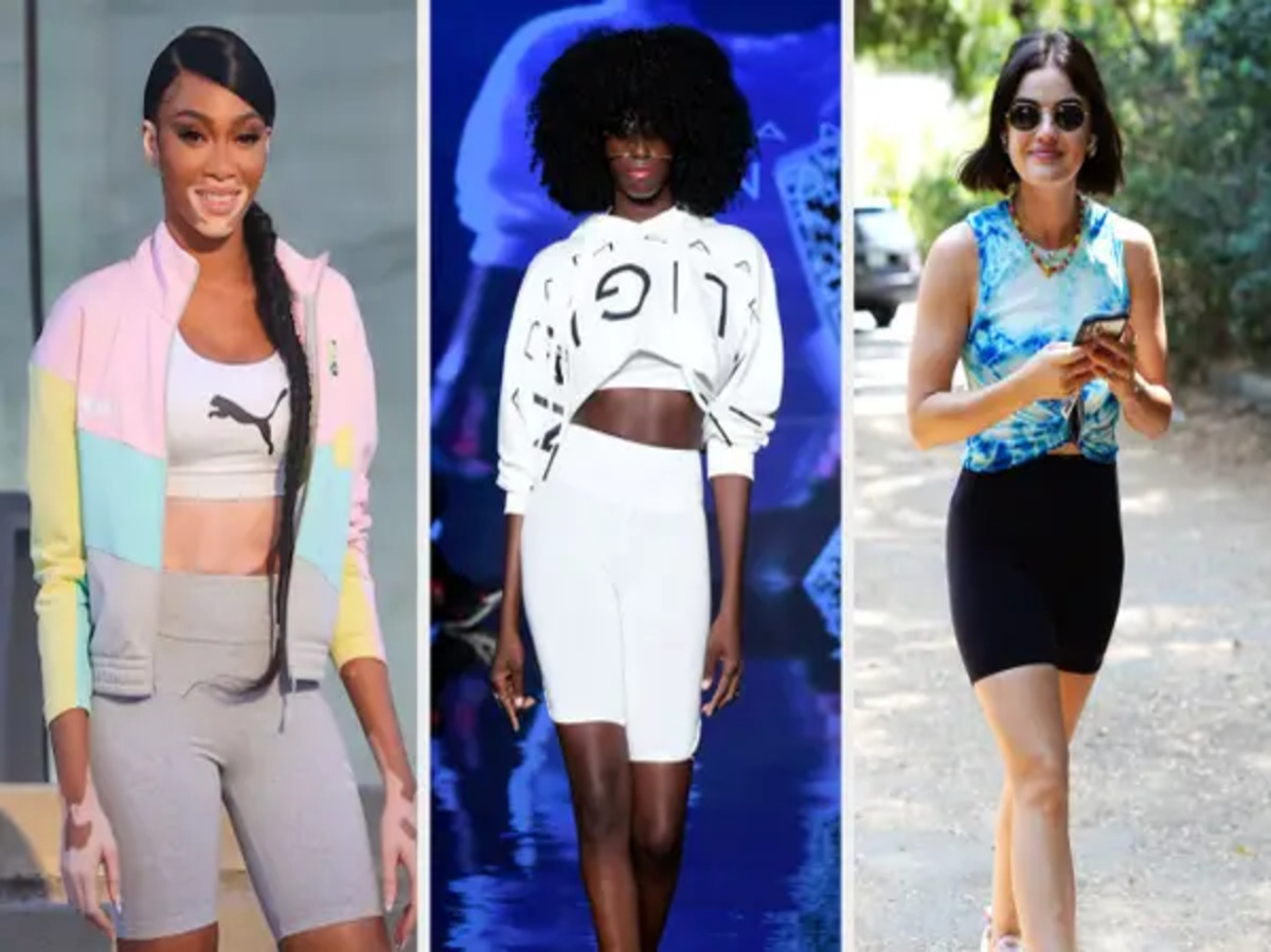 A stylish individual wearing biker shorts paired with an oversized t-shirt and sneakers.