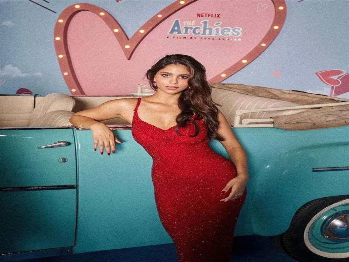 Suhana Khan standing in a red dress at the promotional event for her series ARCHIES.