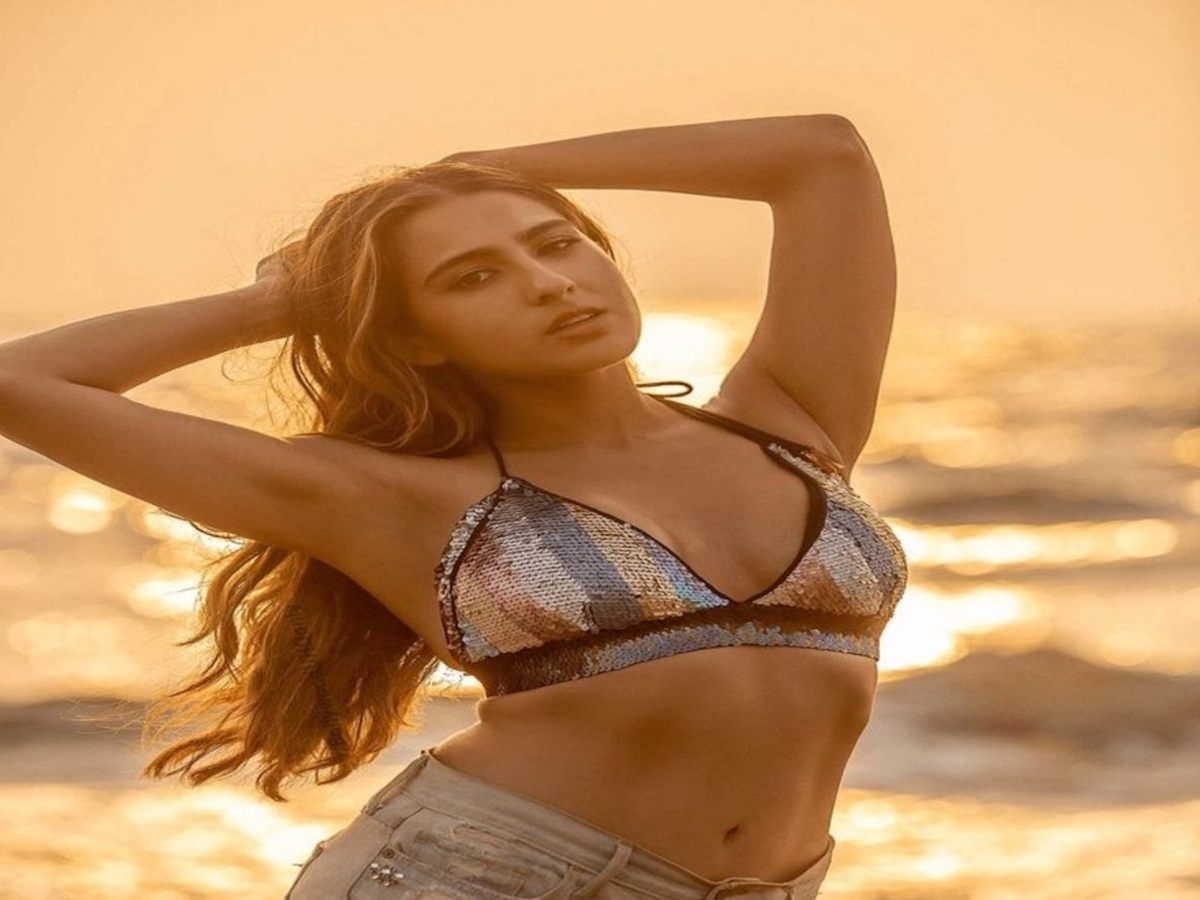 Sara Ali Khan enjoying a beach sunset in a fashionable bikini and shorts during her Maldives vacation.