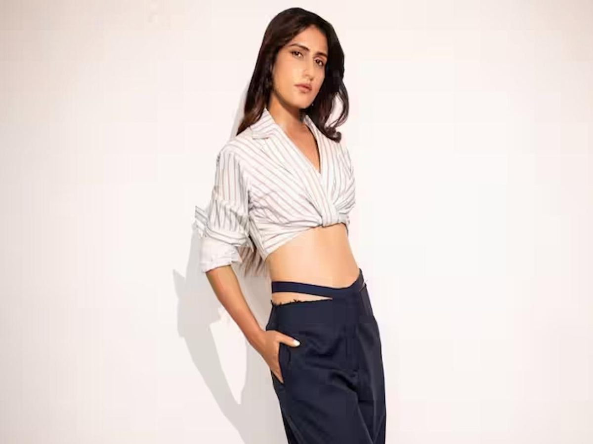 Shirt with collared neckline and rolled-up sleeves adding style to the outfit.