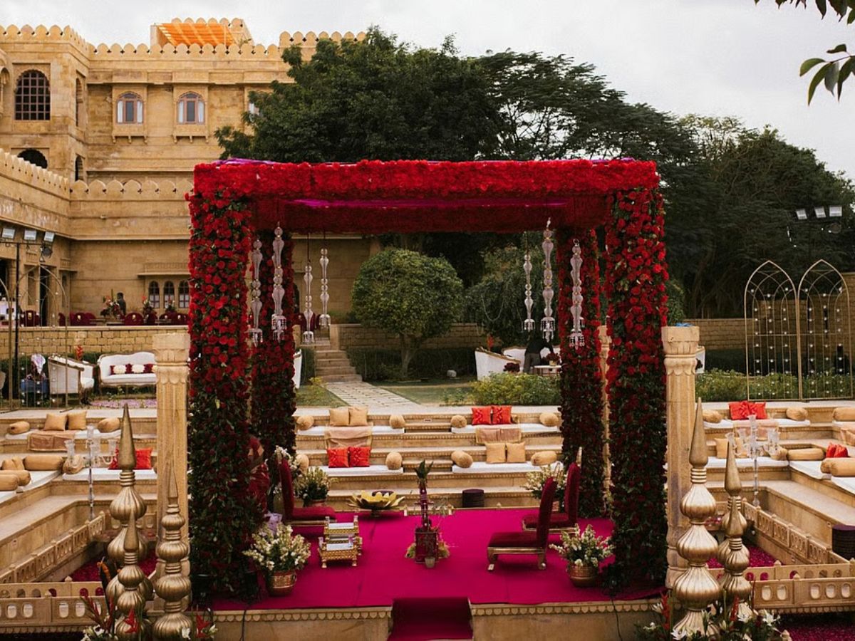 A Royal Mandap Adorned With Bouquets and Bouquets of Red Roses